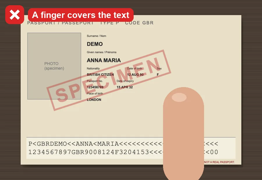 A finger covering part of the passport page